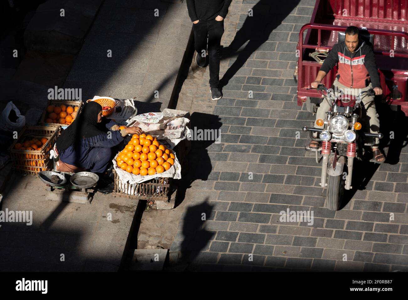 Una donna locale che vende arance sulla strada vicino Zuwayla Gate, il Cairo, Egitto Foto Stock
