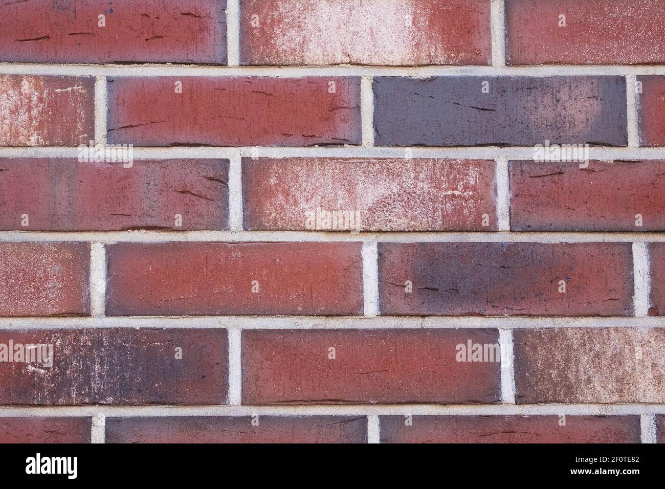Muro di mattoni di colore rosso. Sfondo urbano. Foto Stock