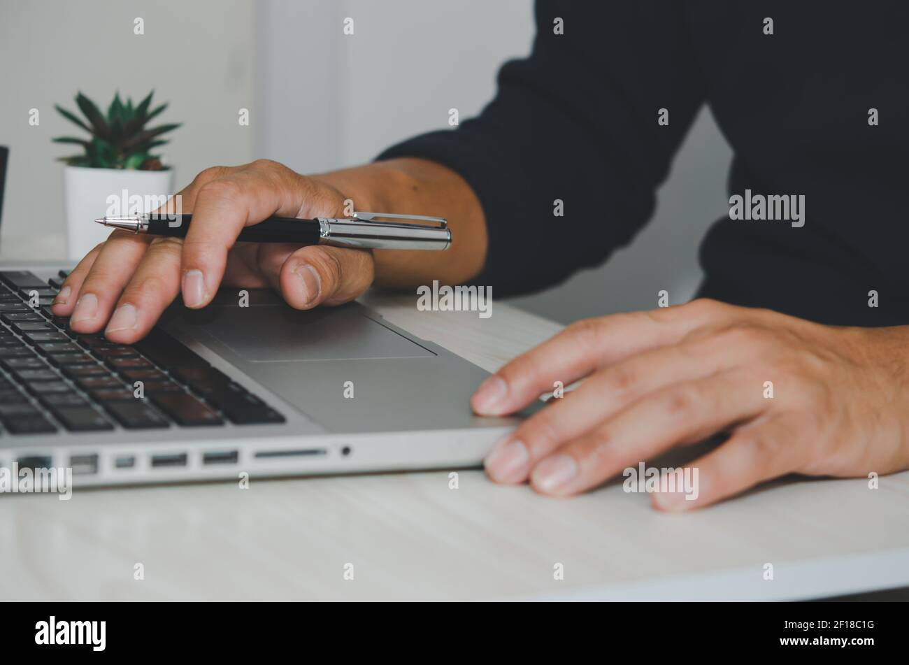 Mano dell'uomo che usa la tastiera del computer portatile. Cerca in internet, informazioni, social networks.Businesses che commerciano acquisti online. Foto Stock