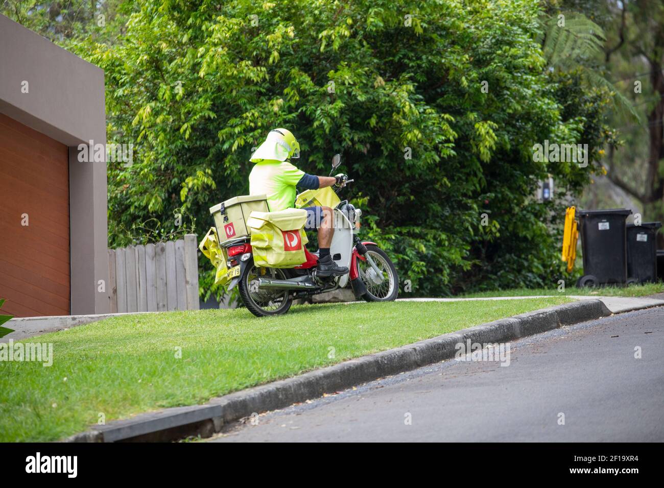 Australia consegna posta postale postman riding moto consegna posta a Sydney homes, NSW, Australia Foto Stock