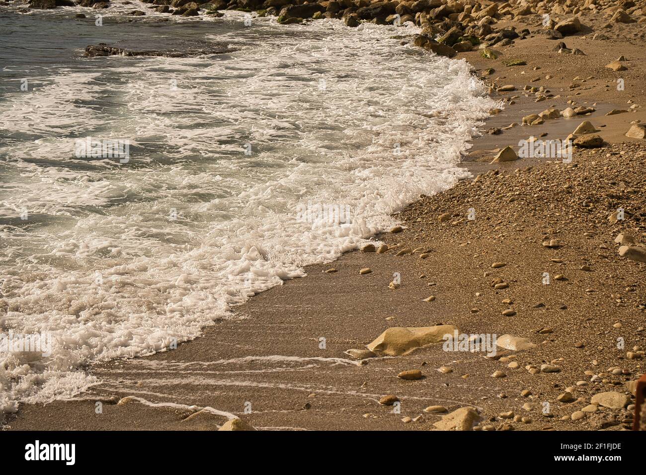 Mare onde lasco linea impatto roccia sulla spiaggia, situato ad Alicante, Spagna Foto Stock