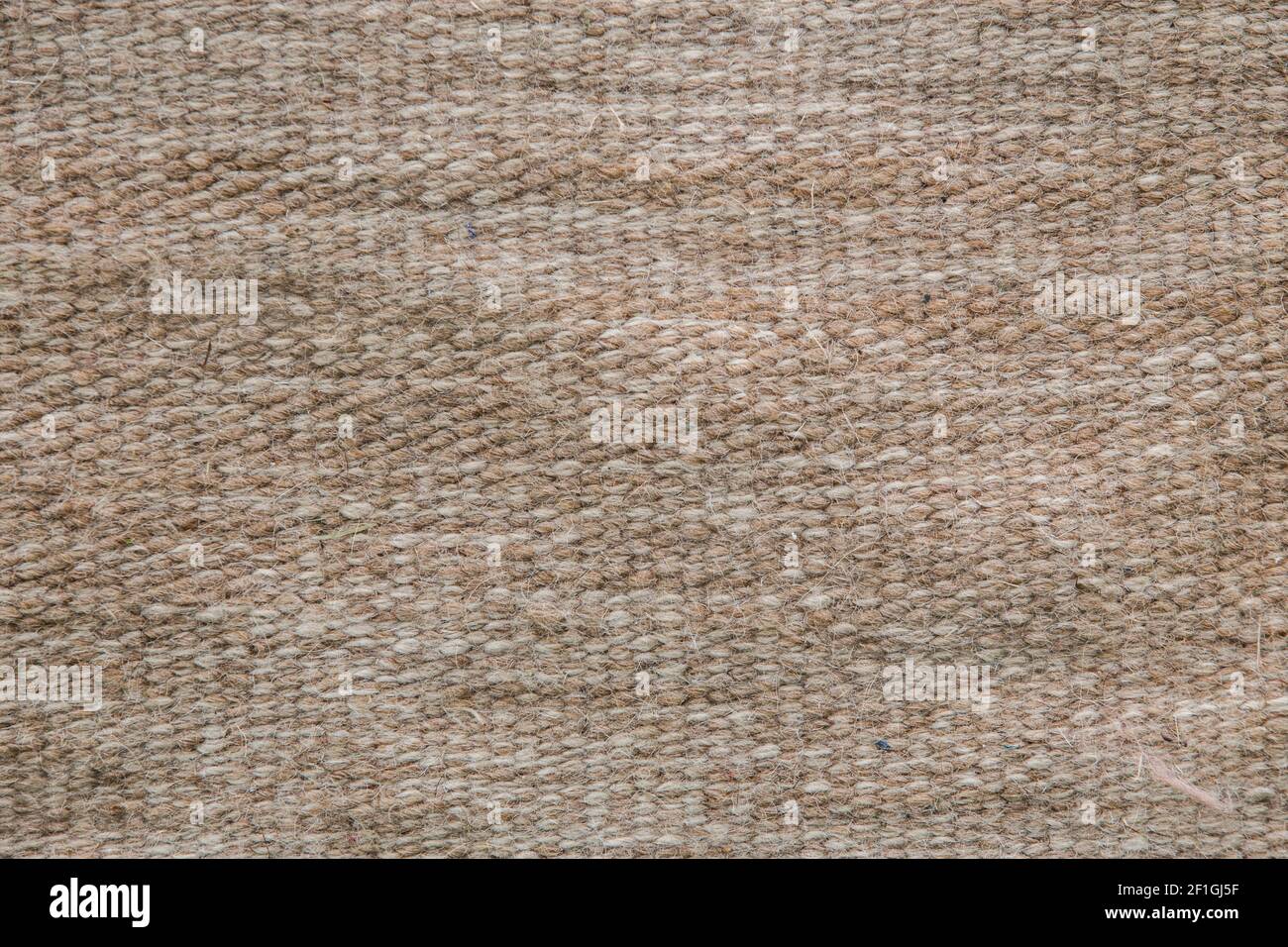 Tappeto lavorato a maglia di lana di tessitura ruvida. Primo piano. Sfondo. Foto Stock