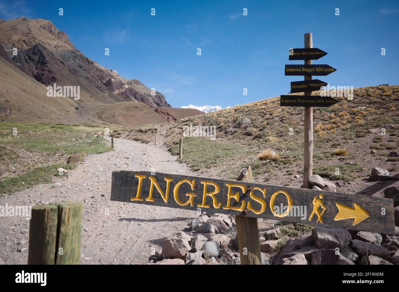 Cartello direzionale con freccia che indica dove si trova l'ingresso sul sentiero escursionistico nel Parco Nazionale di Aconcagua, Andes Mountains, Argentina. Ingreso dallo spagnolo Foto Stock