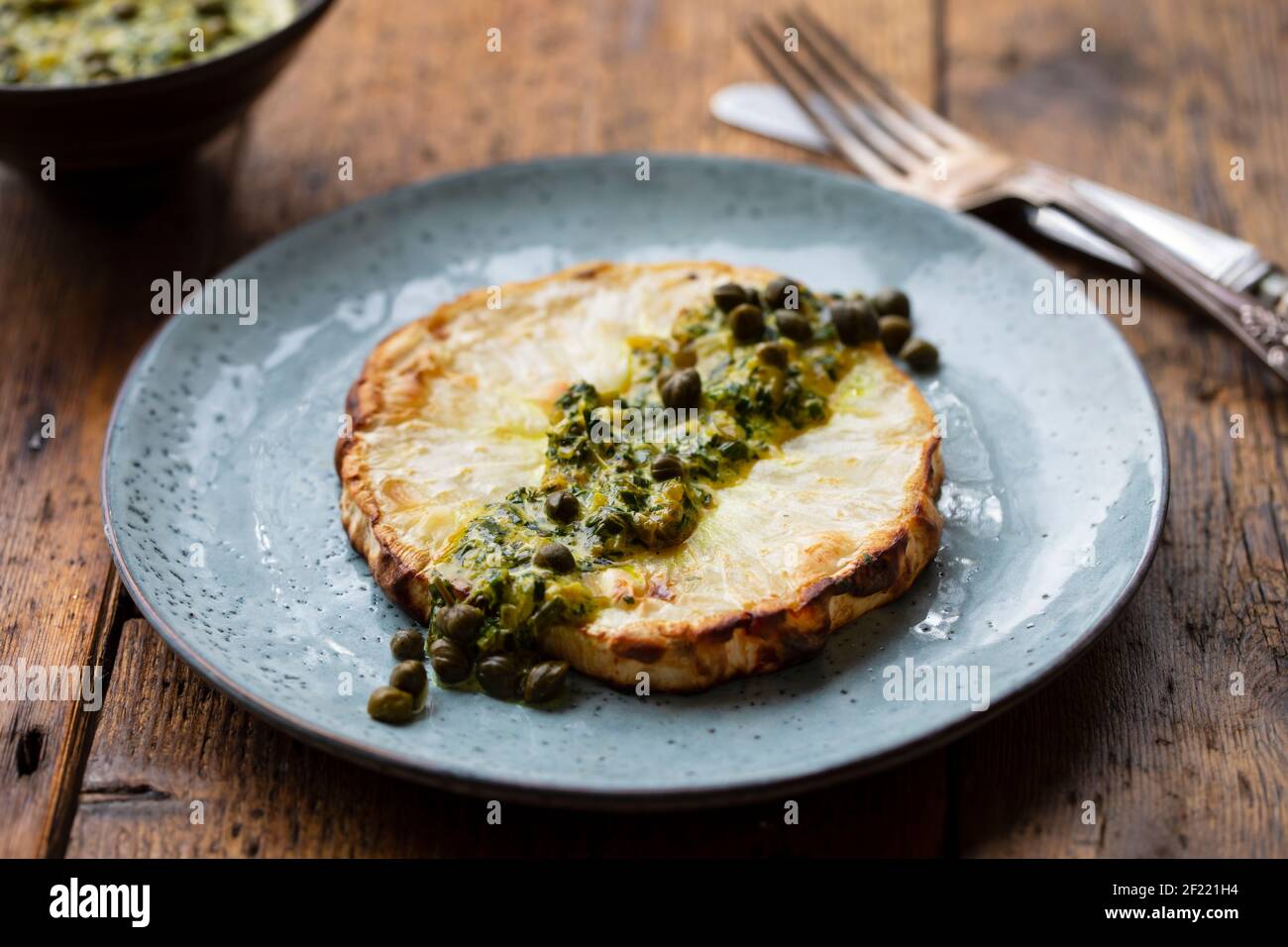 Bistecca di sedano arrosto con capperi e salsa alle erbe Foto Stock