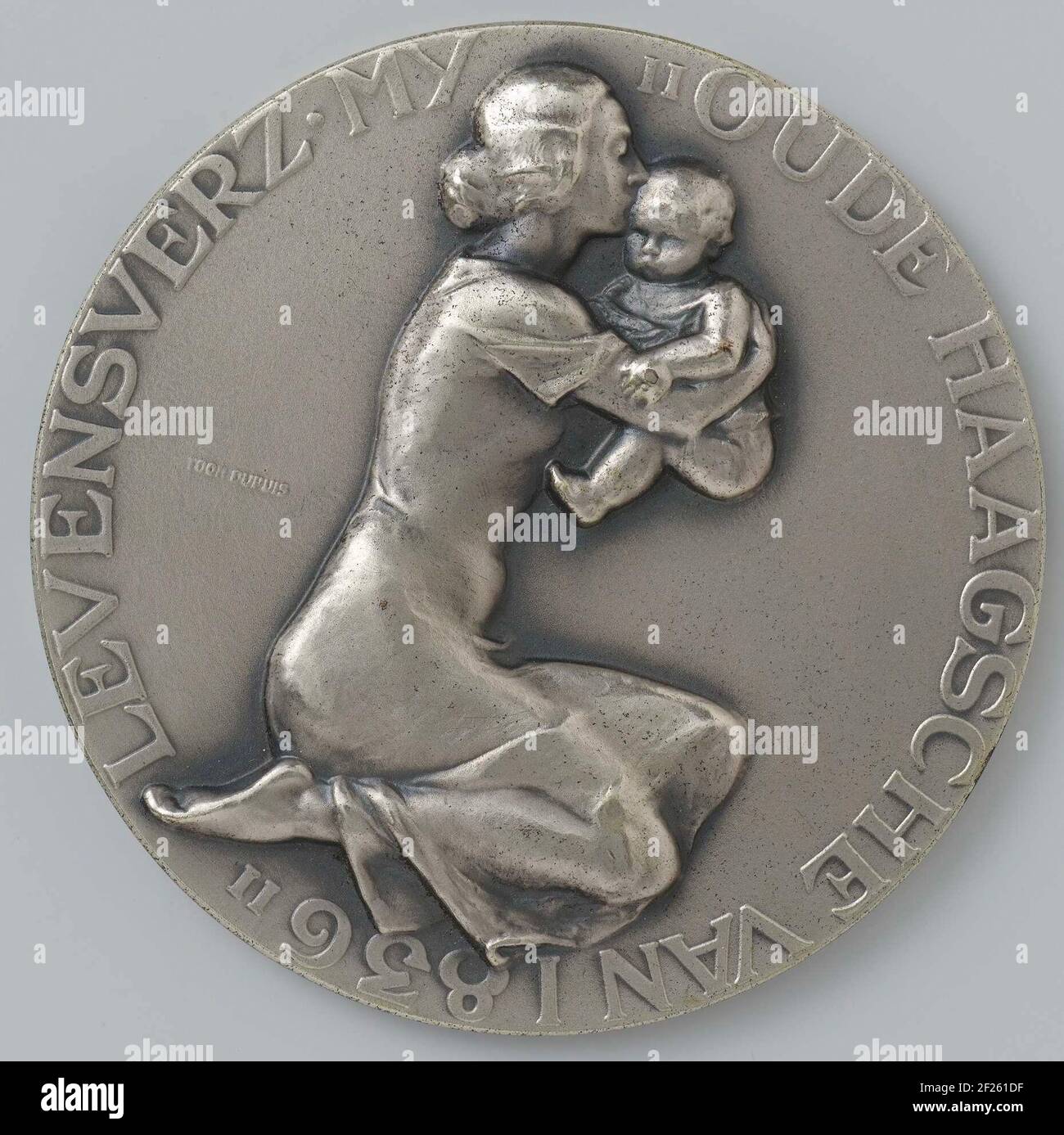 100-jarig bestaan van de Levensverzekeringsmaatschappij 'Oude Haagsche van 1836'.medaglia d'argento. Davanti una donna inginocchiata e un profil a destra con un piccolo bambino tra le braccia dà un bacio, per iscritto; downside: Campo vuoto all'interno dei tendini. Foto Stock