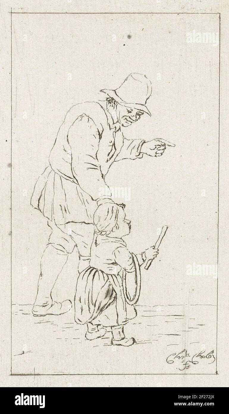 L'uomo di Staande ha incontrato genere hoepel.A padre gioca con suo figlio. Ha il bambino a portata di mano. Il figlio ha un cerchio e un bastone con cui può estrarre il cerchio. Foto Stock