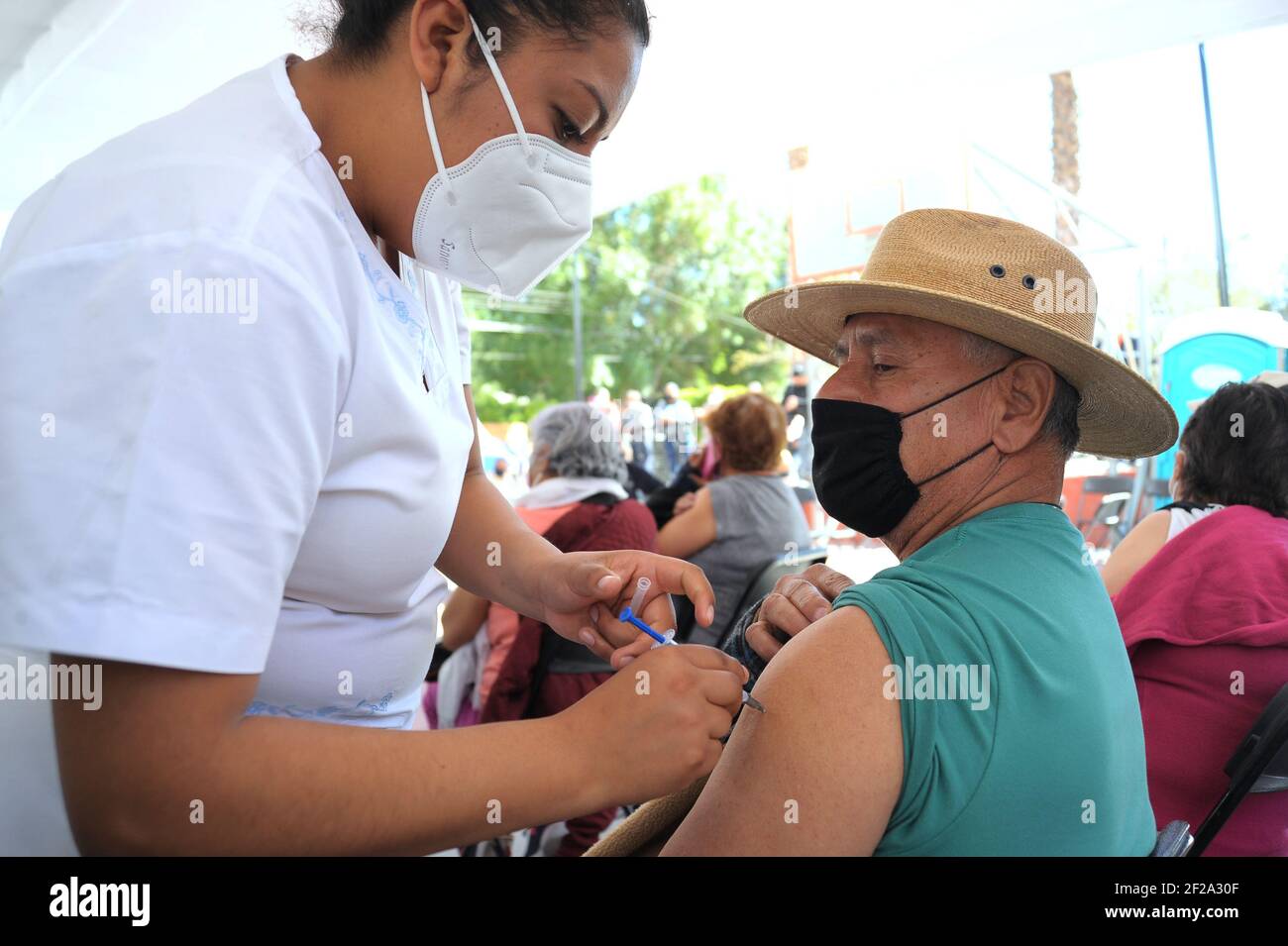 Non esclusivo: QUERETARO, MESSICO - MARZO 10: Un infermiere somministra una dose di vaccino Pfizer ad un anziano, durante un programma nazionale di vaccinazione a imm Foto Stock