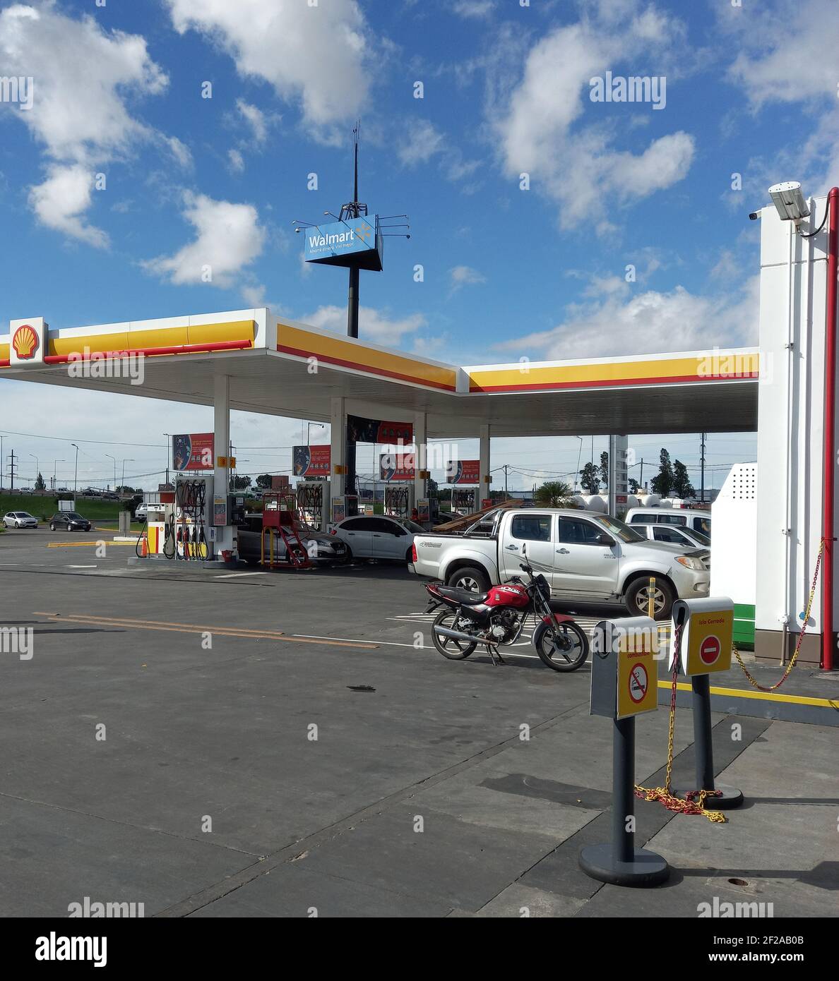 SARANDI, AVELLANEDA, BUENOS AIRES, ARGENTINA - Feb 11, 2021: Centro commerciale. Colpo di auto presso la stazione di benzina Shell accanto all'autostrada. Soleggiato d Foto Stock