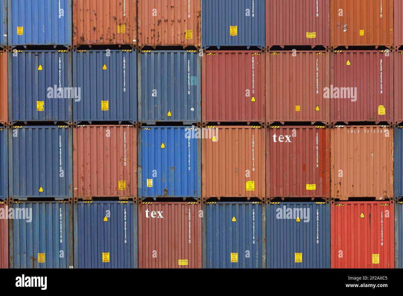 Pila di contenitori per la spedizione del carico in Porto, parete colorata di contenitori per il trasporto in cantiere. Seamless Texture Industrial background, Porto di Dublino, Mare Foto Stock