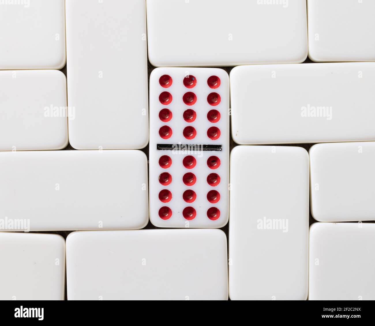 Doppio di dodici domino con punti rossi circondati da tessere vuote Foto Stock