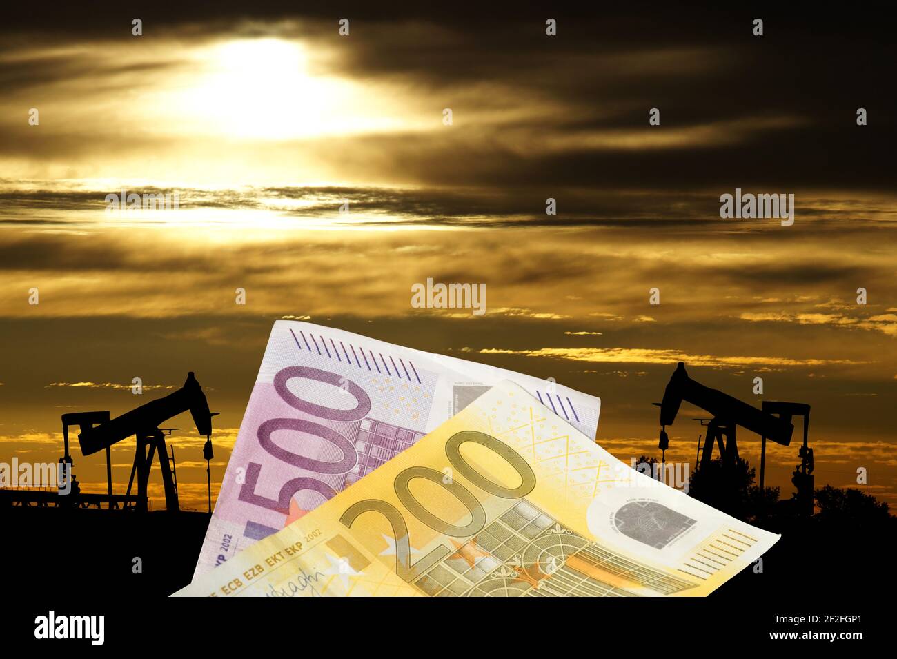 Banconote in euro e un campo petrolifero Foto Stock