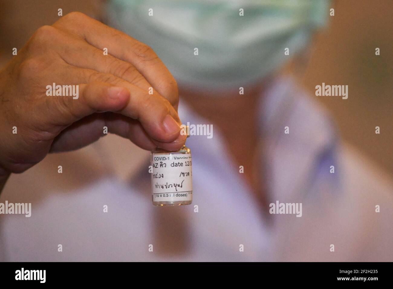 Thailandia. 12 marzo 2021. Un operatore sanitario detiene una bottiglia di vaccino AstraZeneca COVID-19 con il nome del primo ministro tailandese Prayuth Chan-ocha scritto su di esso, presso l'ospedale Bambasnaradura di Bangkok. Prayuth e i membri del suo gabinetto hanno annullato il piano di ricevere gli shot di AstraZeneca venerdì, in seguito alle relazioni sui coaguli di sangue e la sospensione in alcuni paesi europei. (Foto di Vichan Poti/Pacific Press/Sipa USA) Credit: Sipa USA/Alamy Live News Foto Stock