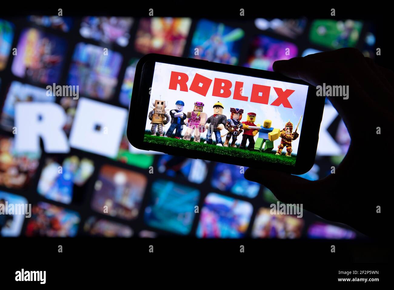 LONDRA, Regno Unito - Marzo 2021: Persona che tiene uno smartphone con il logo del gioco roblox Foto Stock
