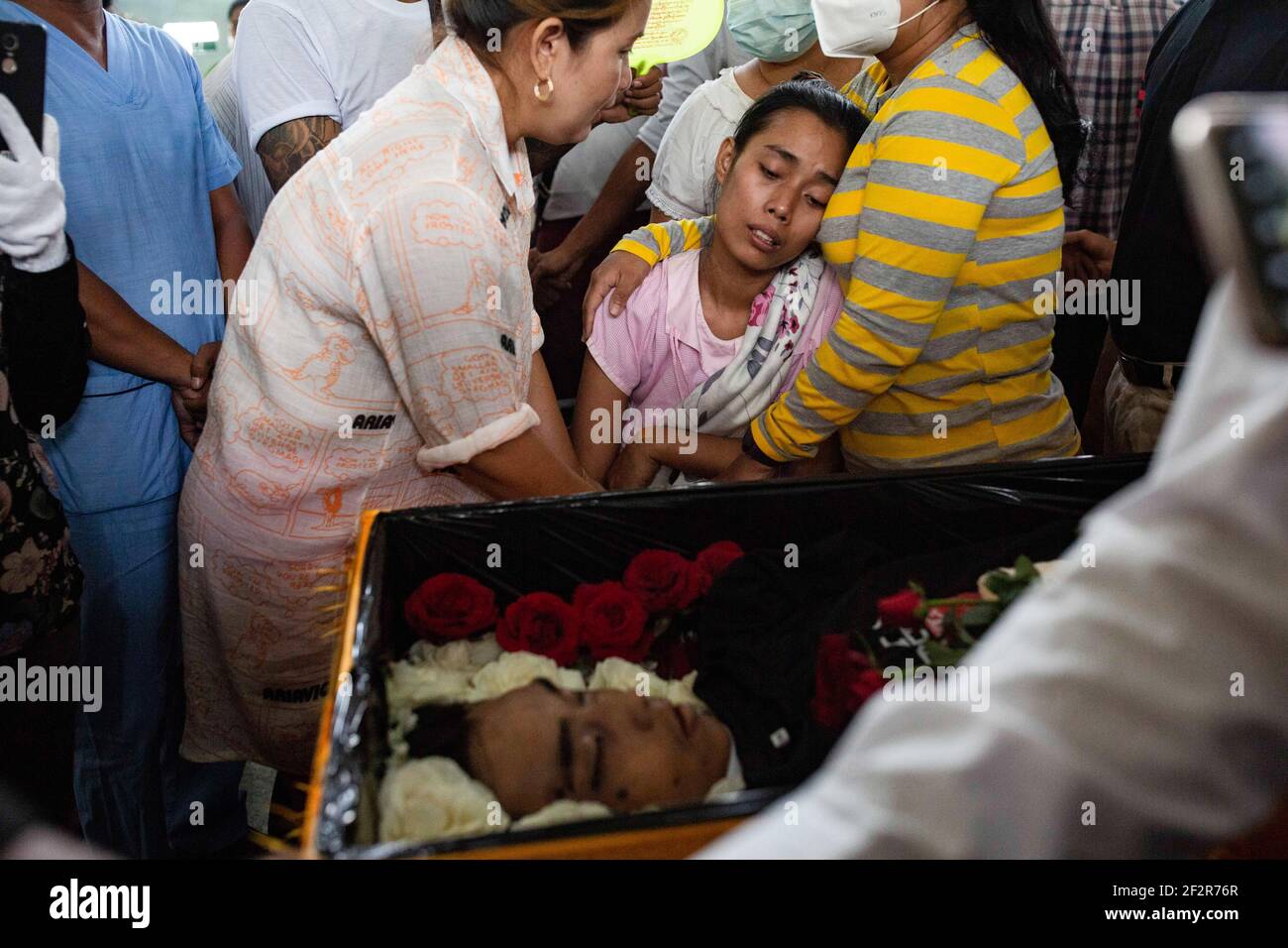 (NOTA DELLA REDAZIONE: Immagine della morte) un parente reagisce ai funerali di Chit min Thu, un manifestante pro-democrazia ucciso dalle forze di sicurezza durante una dimostrazione contro il colpo di stato militare a Yangon dove le forze di sicurezza del Myanmar hanno attaccato i dimostranti con proiettili di gomma, munizioni vive, gas lacrimogeni e bombe stordenti uccidendo diversi manifestanti. L'esercito del Myanmar ha arrestato il consigliere di Stato del Myanmar Aung San Suu Kyi il 01 febbraio 2021 e ha dichiarato uno stato di emergenza mentre coglie il potere nel paese per un anno dopo aver perso l'elezione contro la Lega nazionale per la democrazia (NLD). Foto Stock