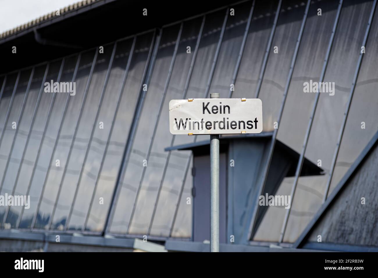 Nessun cartello di avvertenza manutenzione invernale in tedesco contro la facciata riflettente Foto Stock