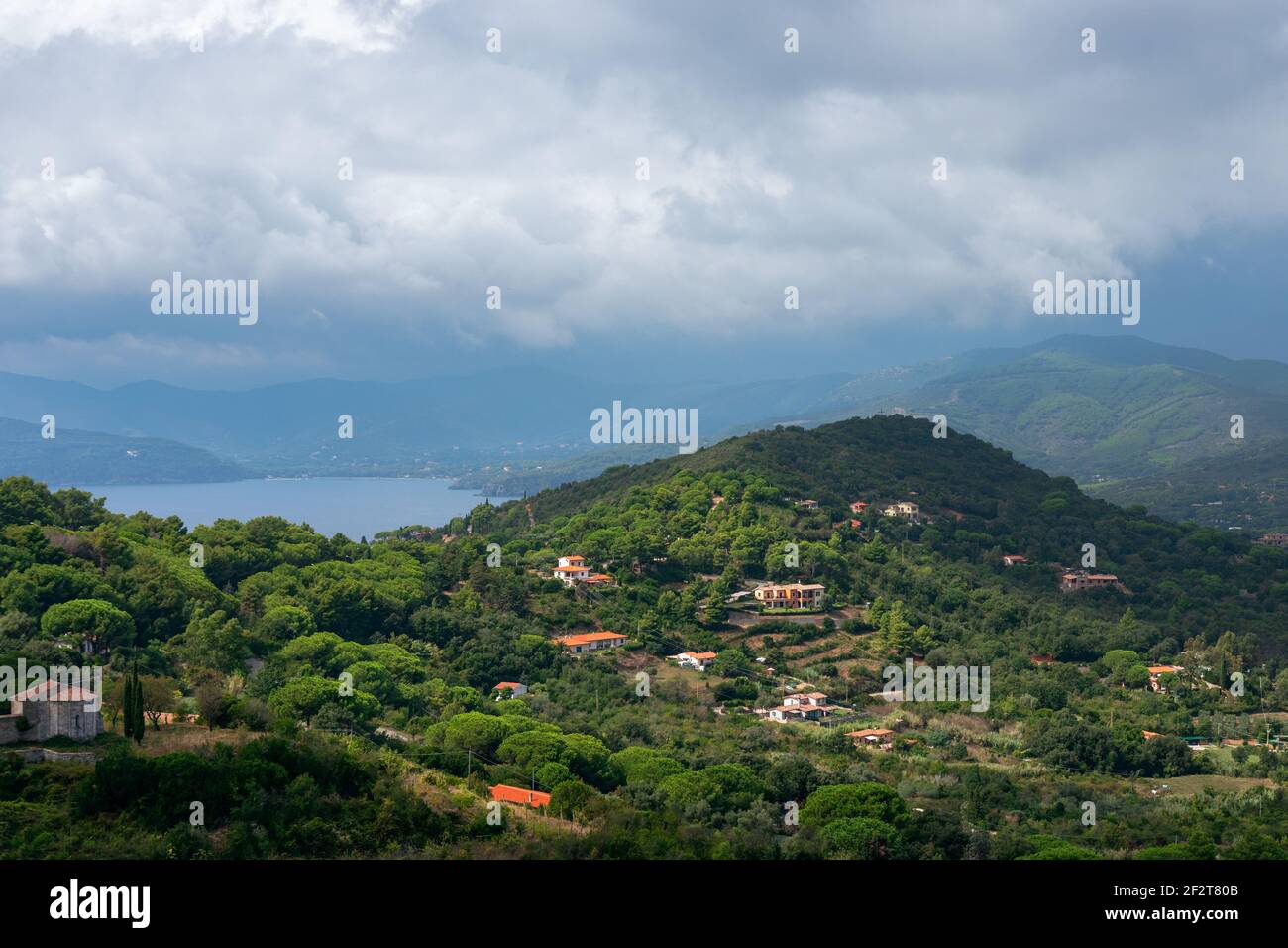 Bella vista sulle colline e la laguna di mare sotto un cielo nuvoloso sull'Isola d'Elba in Toscana, Italia Foto Stock