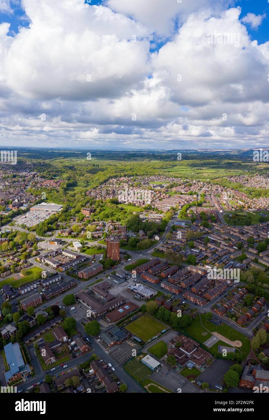 Foto aerea di una tipica proprietà immobiliare britannica nella grande città di Wigan, che mostra una vista dall'alto del drone di strade suburbane, strade e file di hous Foto Stock