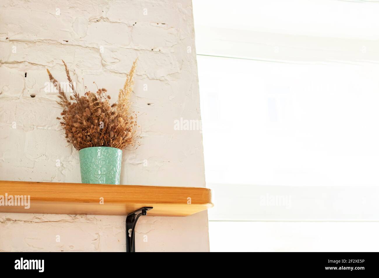 Bouquet di erbario su una mensola di legno vicino alla finestra Foto Stock