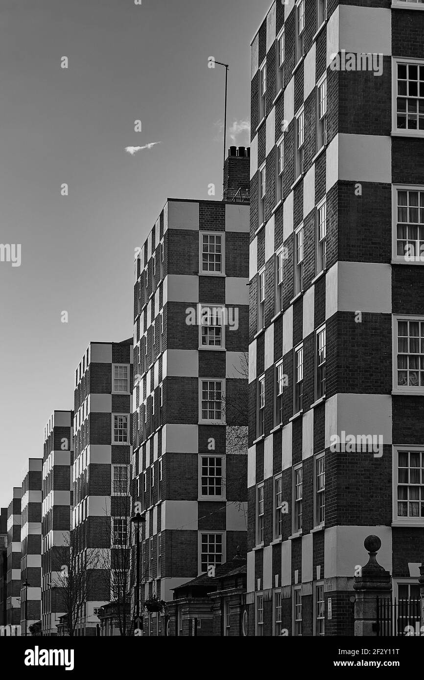 Immagine monocromatica in bianco e nero di edifici di appartamenti dall'aspetto unico A Londra con esterni quadrati e a scacchi Foto Stock