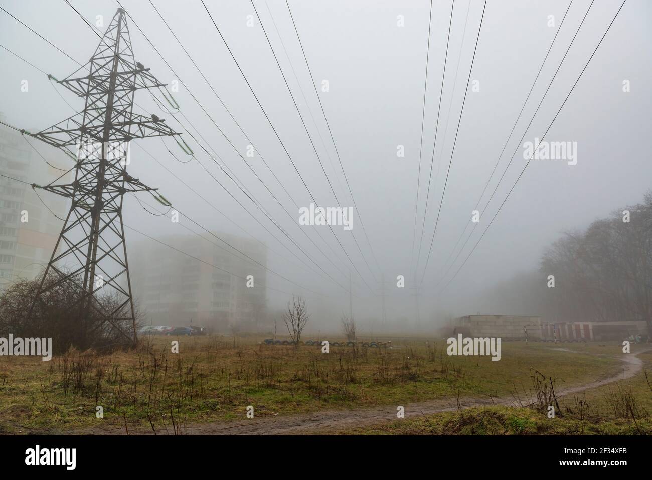 Linee elettriche in ambiente urbano. Giornata di nebbia nella grande città Foto Stock