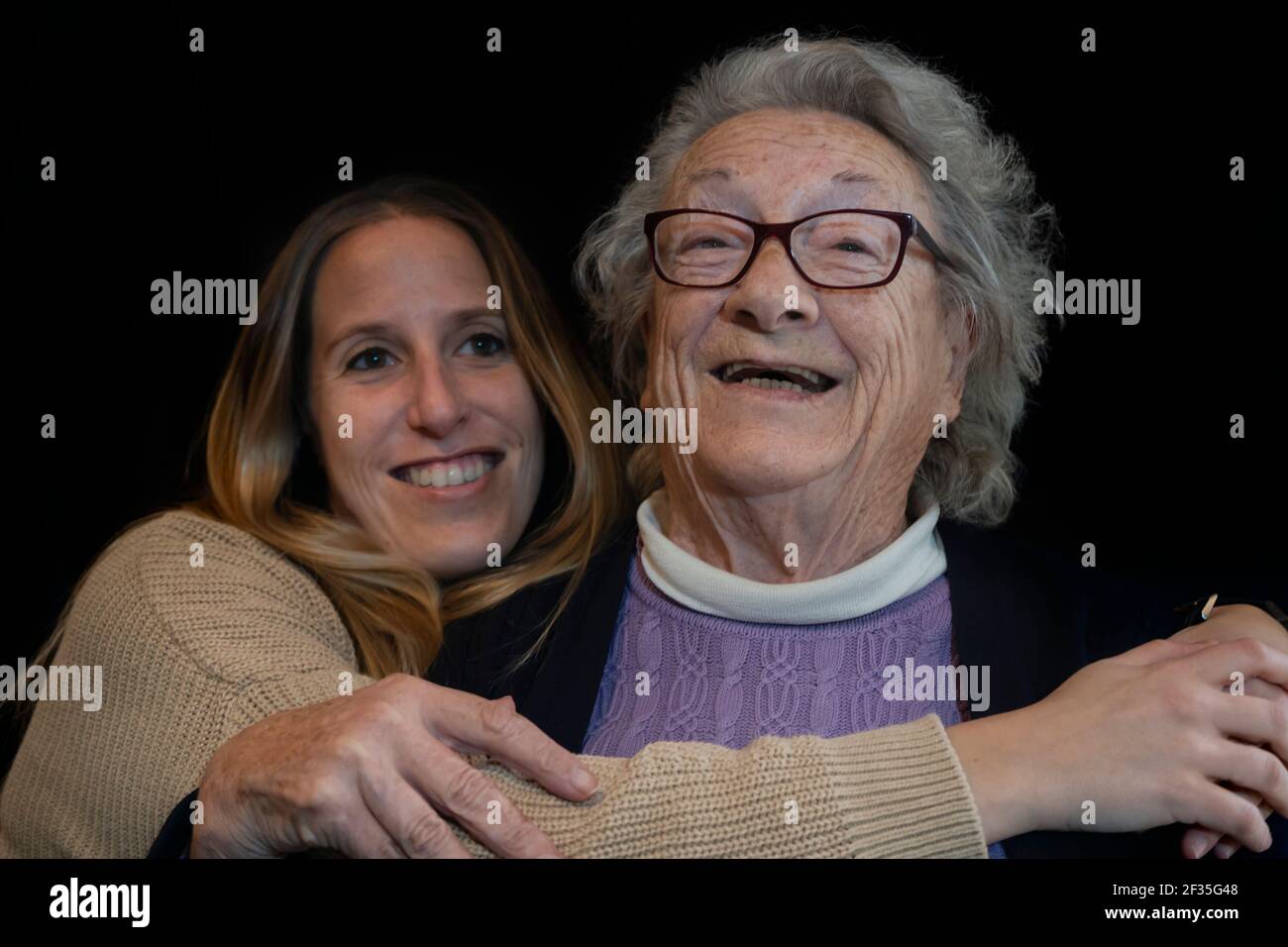 Ritratto di stile di vita familiare di anziana anni 80 donna abbracciando giovane grande figlia.Happy persone insieme sorridente concetto. Foto Stock