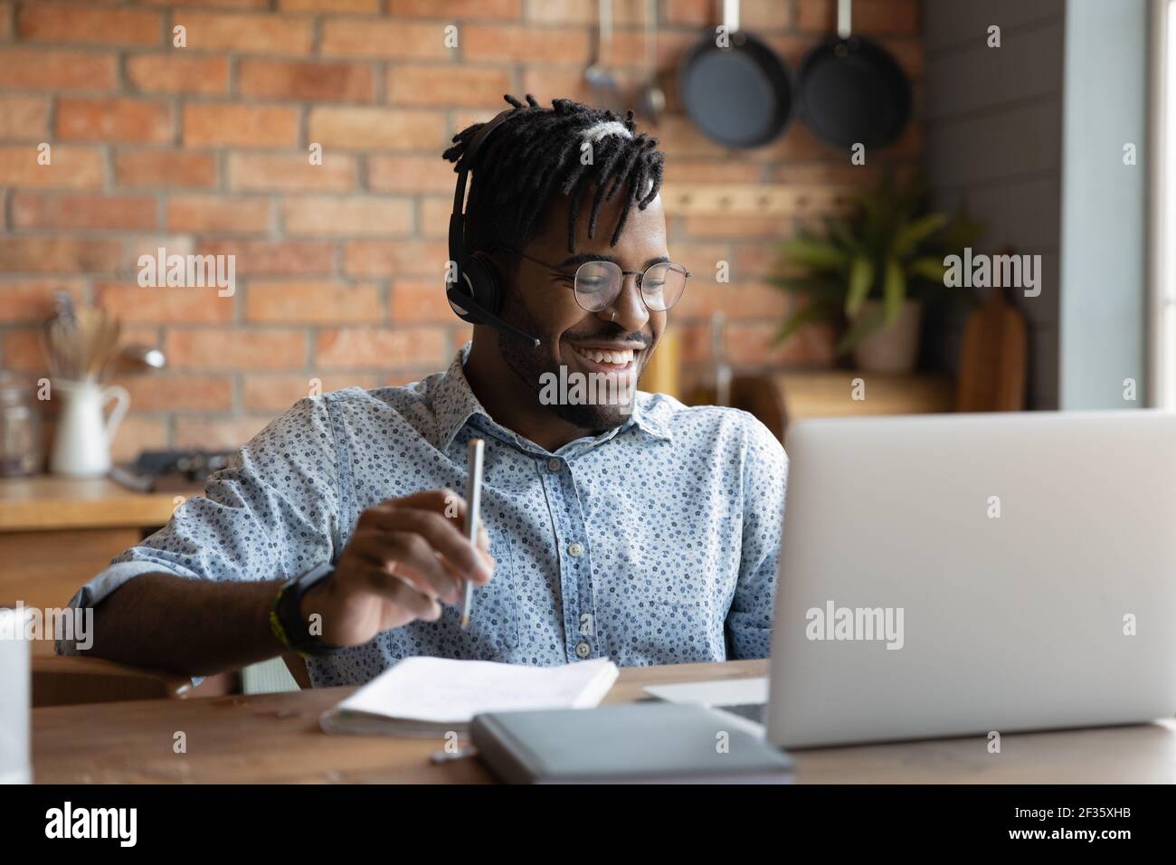 Ridendo giovane africano guy goda una buona scherzata sullo schermo del laptop Foto Stock