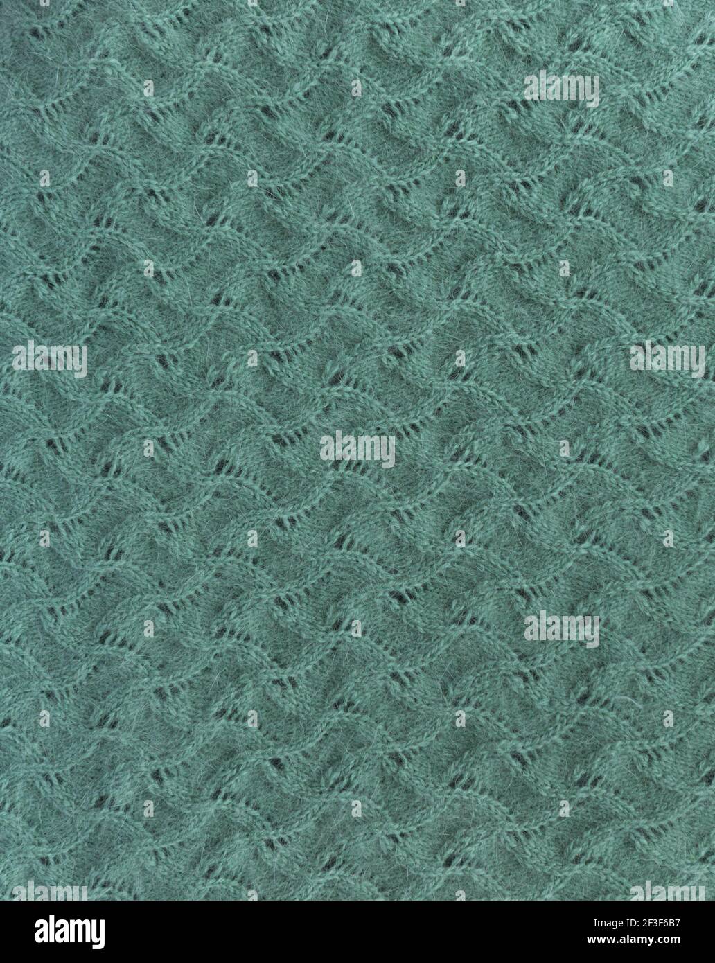Unione astratta di ripetizione. Primo piano di tessuto di lana lavorato a maglia. Unione di ripetizione come sfondo. Foto Stock