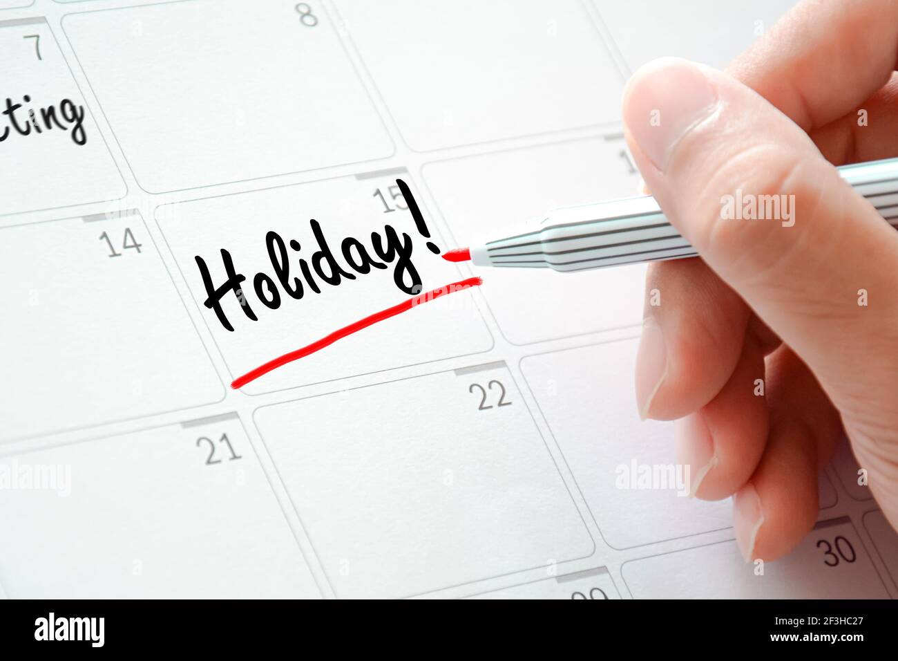 Testo delle festività sul calendario (o sul pianificatore della scrivania) sottolineata con contrassegno rosso Foto Stock