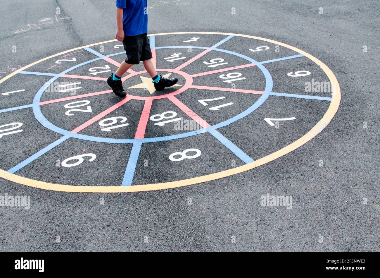 Scolari primari che giocano in un parco giochi scolastico in una pausa tra le lezioni in classe. Foto Stock