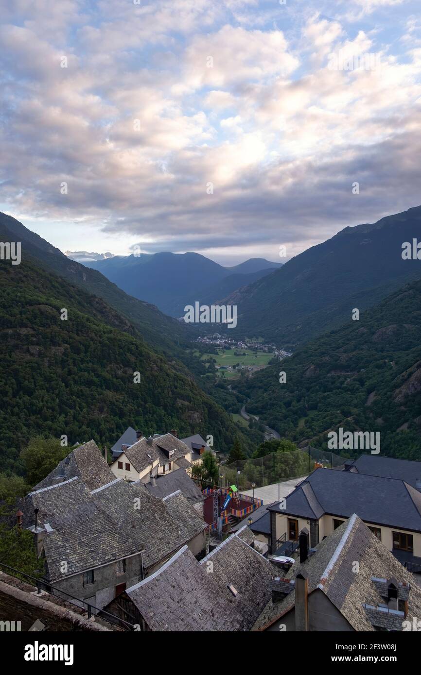 Tramonto vista aerea del villaggio catalano dei Pirenei di Canejan con Bosost sullo sfondo della Valle di Aran, verticale Foto Stock