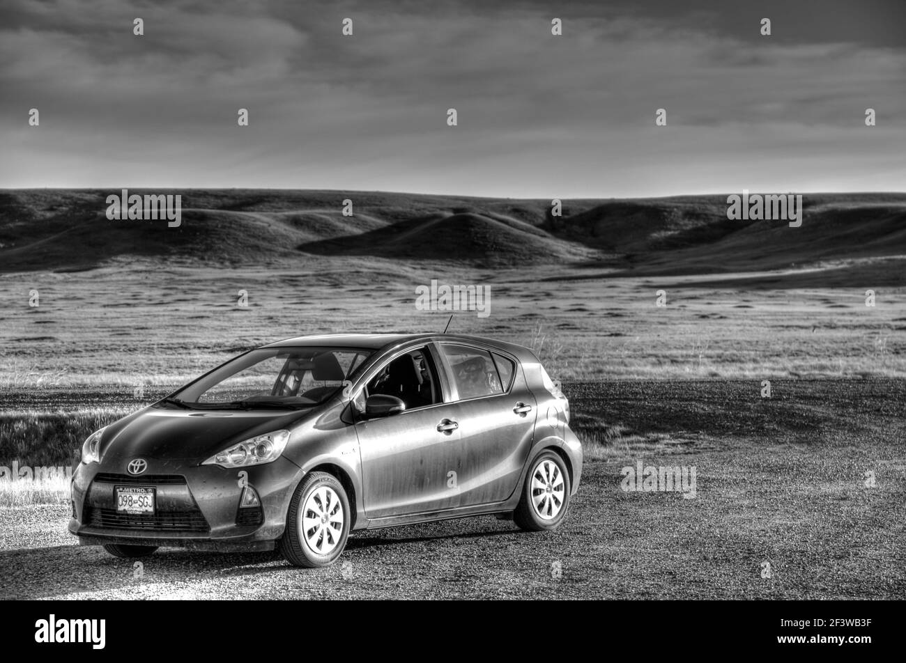 Auto parcheggiate in drammatico paesaggio di prati, pascoli del Parco Nazionale, Saskatchewan Foto Stock