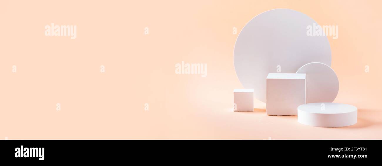 Podio bianco dalle forme geometriche per l'esposizione dei prodotti su sfondo beige. Palco monocromatico, stand per la promozione del prodotto in stile minimale. Spazio di copia per Foto Stock