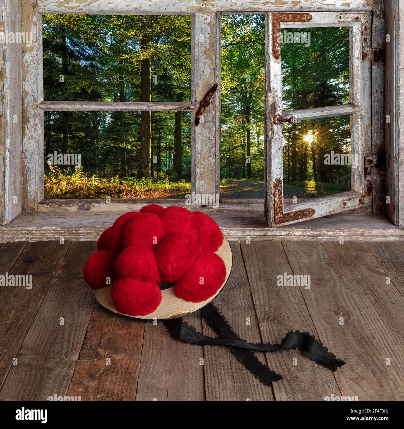 Alter Schwarzwälder Bollenhut vor Holzfenster mit Blick in die Landschaft Foto Stock