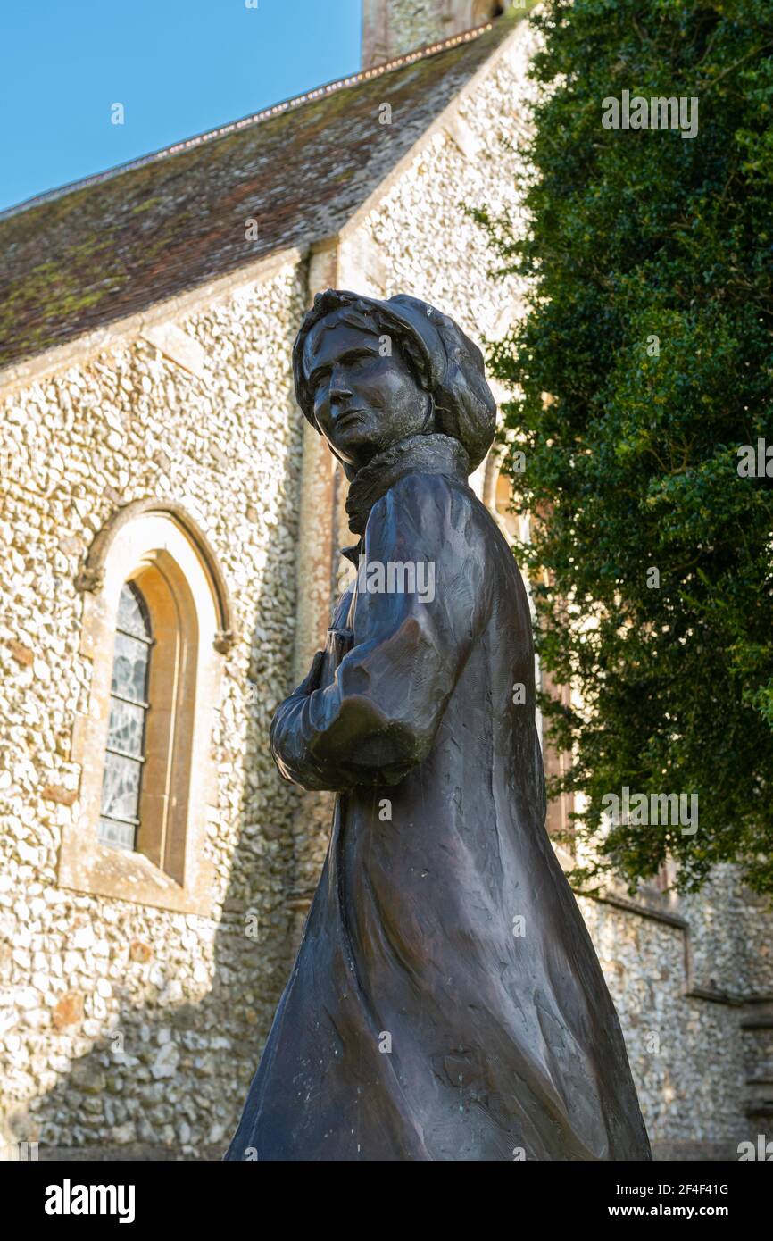 Statua del famoso autore Jane Austen fuori della chiesa di San Nicola nel villaggio Hampshire di Chawton, Inghilterra, Regno Unito Foto Stock