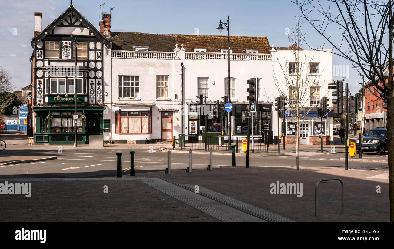 Epsom London UK, March21 2021, un tradizionale pub irlandese e una fila di negozi di High Street senza persone Foto Stock