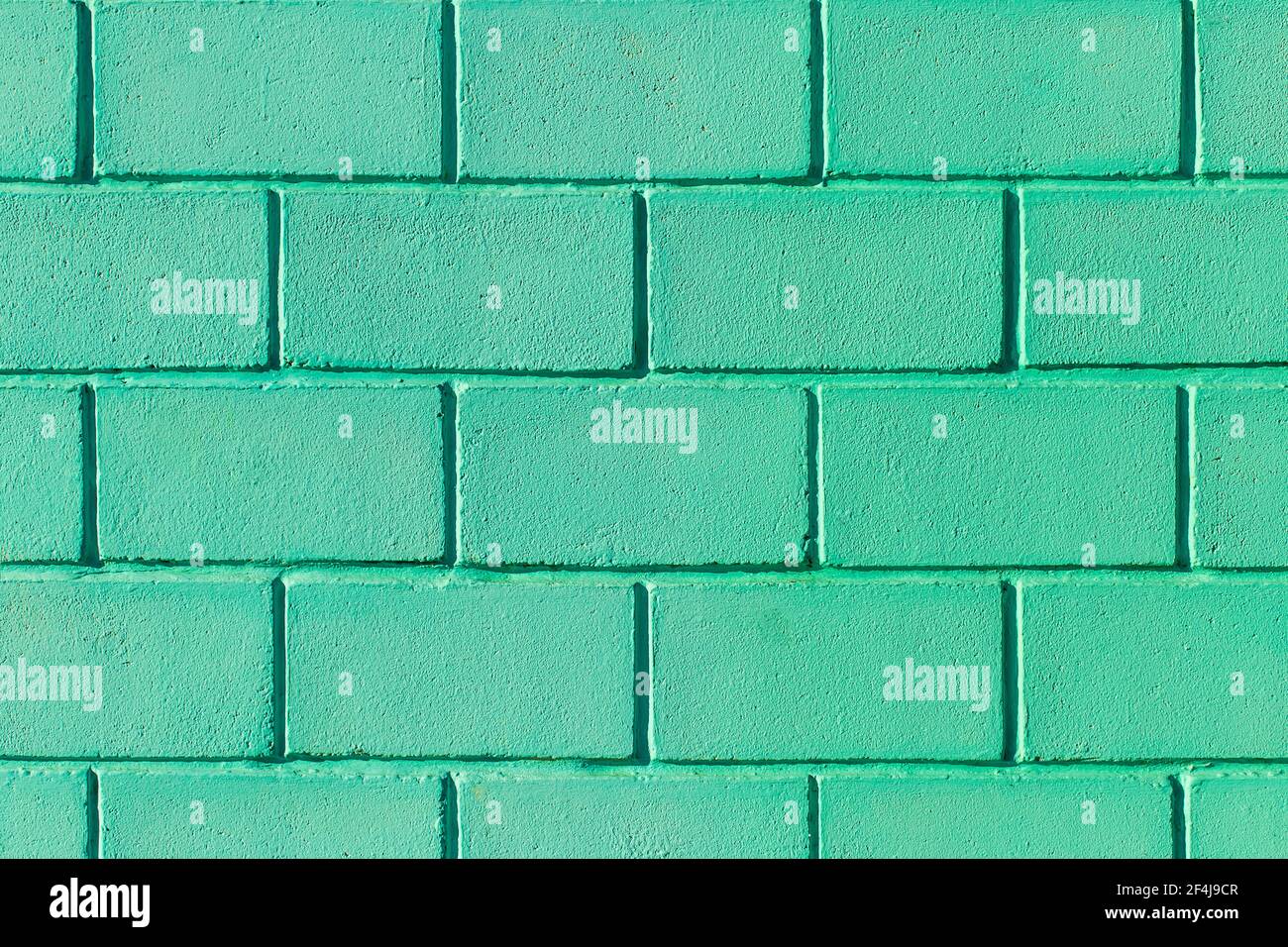 Parete verde o acquamarina fatta di blocchi di mattoni colore texture  sfondo azzurro Foto stock - Alamy