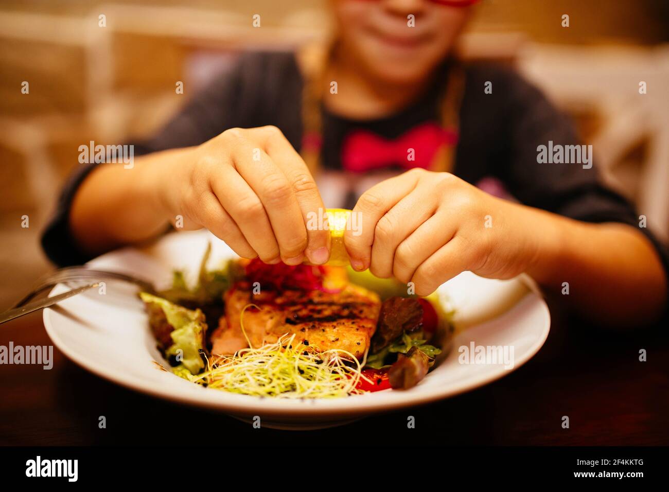 Cibo del ristorante con ingredienti freschi - salmone alla griglia e fresco insalata nel ristorante di lusso con un bicchiere di vino e posate Foto Stock