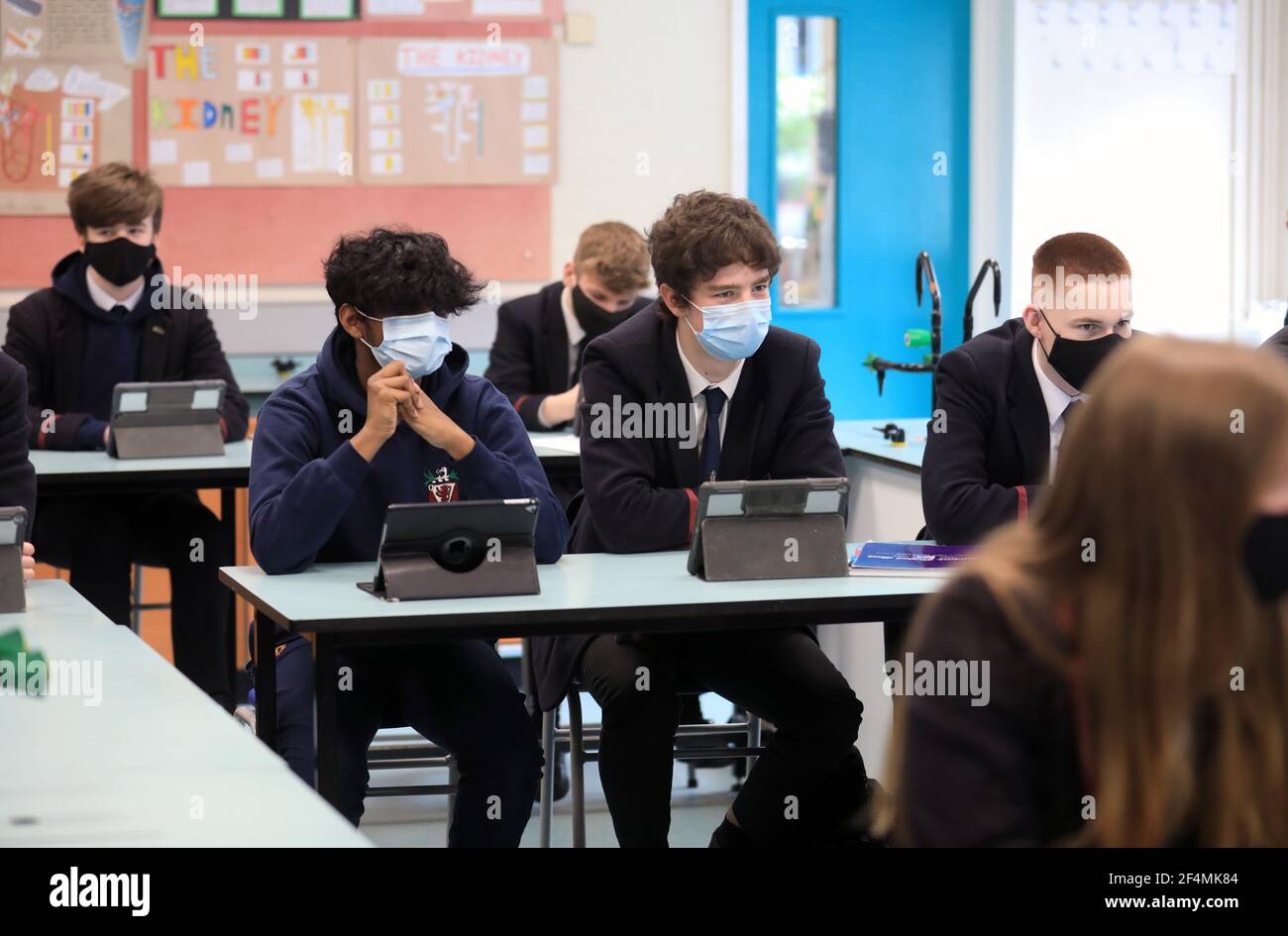 Sesto alunni della scuola superiore di Wallace a Lisburn ascoltate il Ministro dell'Istruzione Peter Weir. Altri sette gruppi di bambini scolastici dell'Irlanda del Nord sono tornati alle classi dopo tre mesi di apprendimento a casa durante il blocco del coronavirus. Data immagine: Lunedì 22 marzo 2021. Foto Stock