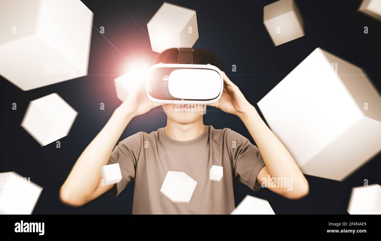 Uomo che indossa occhiali di visore per la realtà virtuale (VR) da utilizzare con smartphone e gioco box. Concetto di tecnologia futura. Foto Stock