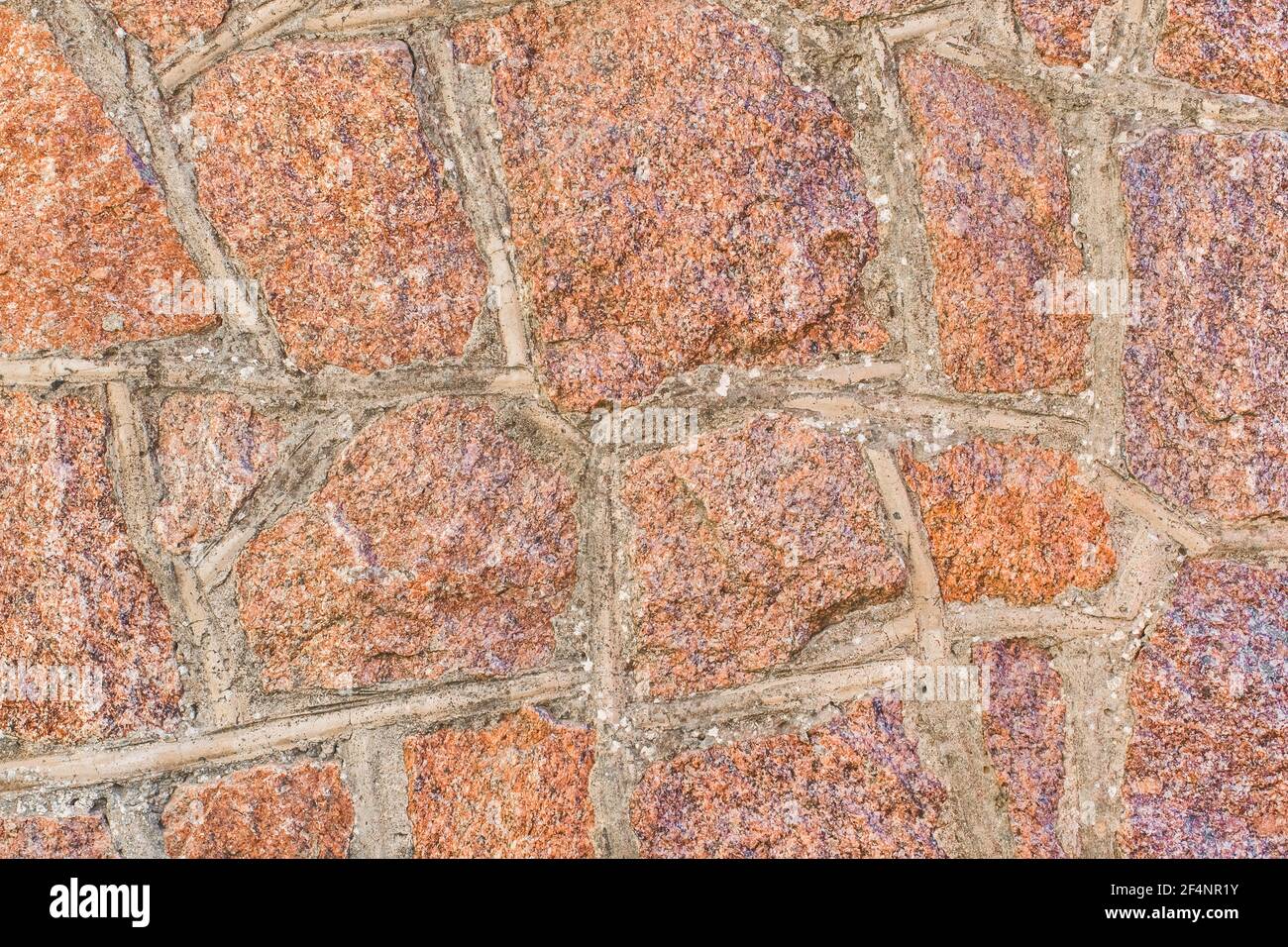 Sfondo rosso e marrone di pietra ciottoli parete texture. Foto Stock