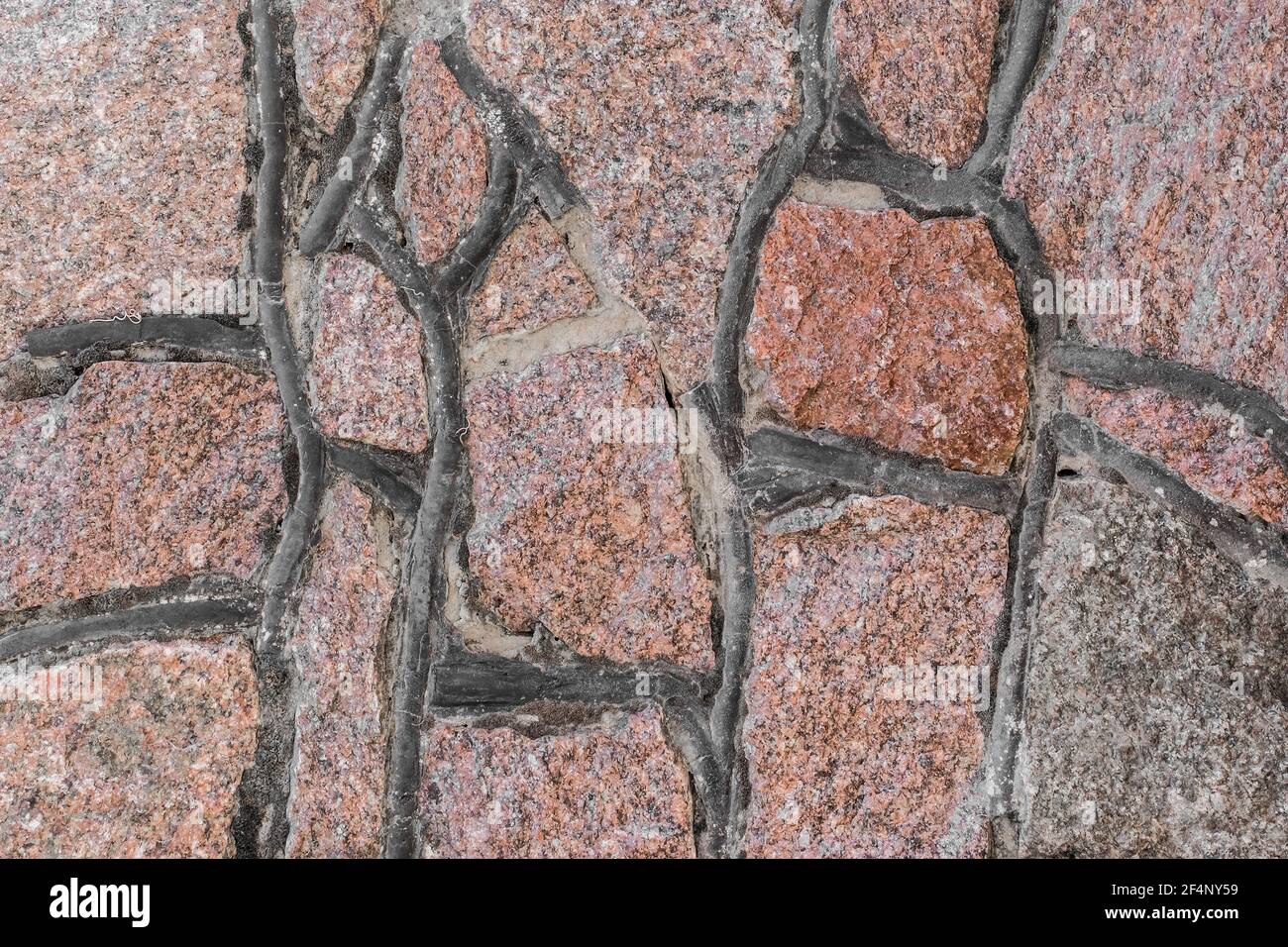 Ciottoli pietra fatta a mano vecchia struttura di parete sfondo. Foto Stock