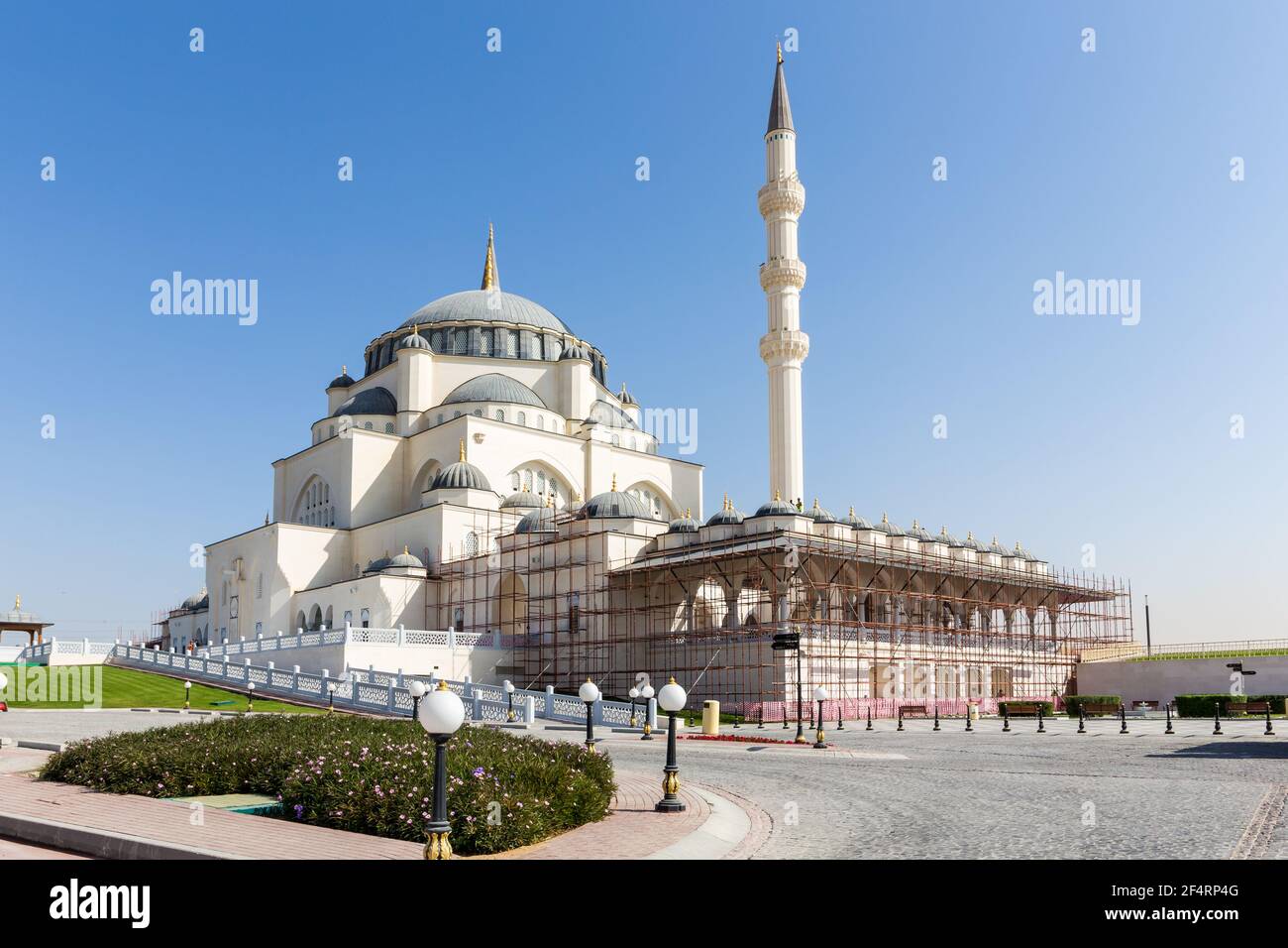 Sharjah Masjid, la moschea di New Sharjah, la più grande moschea dell'Emirato di Sharjah, gli Emirati Arabi Uniti, facciata in arenaria bianca con cupole. Foto Stock