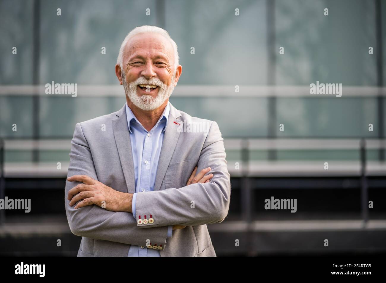 Ritratto esterno di uomo d'affari senior di fronte all'edificio aziendale. Foto Stock