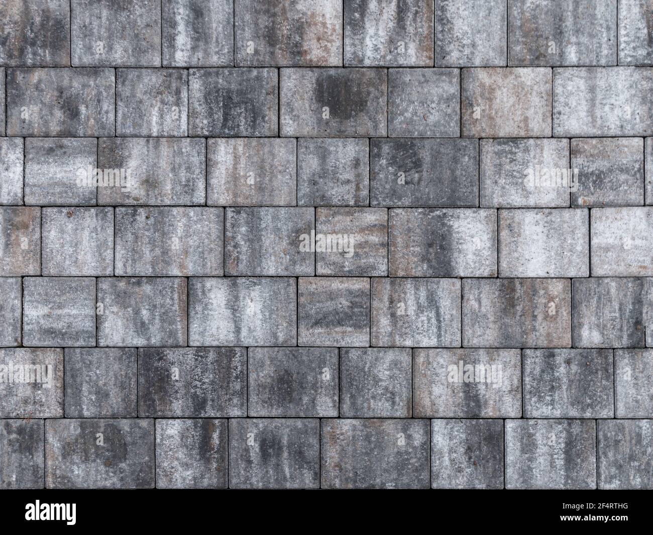 Lastre di pavimentazione grigie, pavimentazione stradale. Texture foto di sfondo senza cuciture Foto Stock