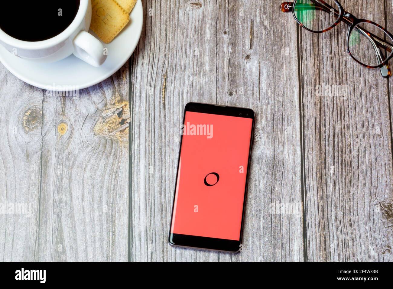 Un telefono cellulare o un telefono cellulare posato su un legno tabella con l'app trasferimento di denaro galassia aperta su schermo Foto Stock