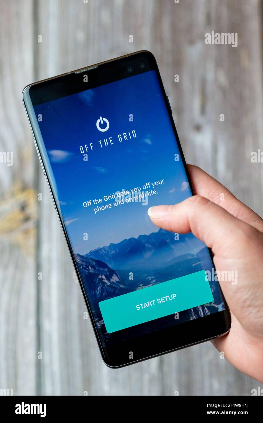 Un telefono cellulare o un telefono cellulare in attesa in un Mano con l'app Off the Grid aperta sullo schermo Foto Stock