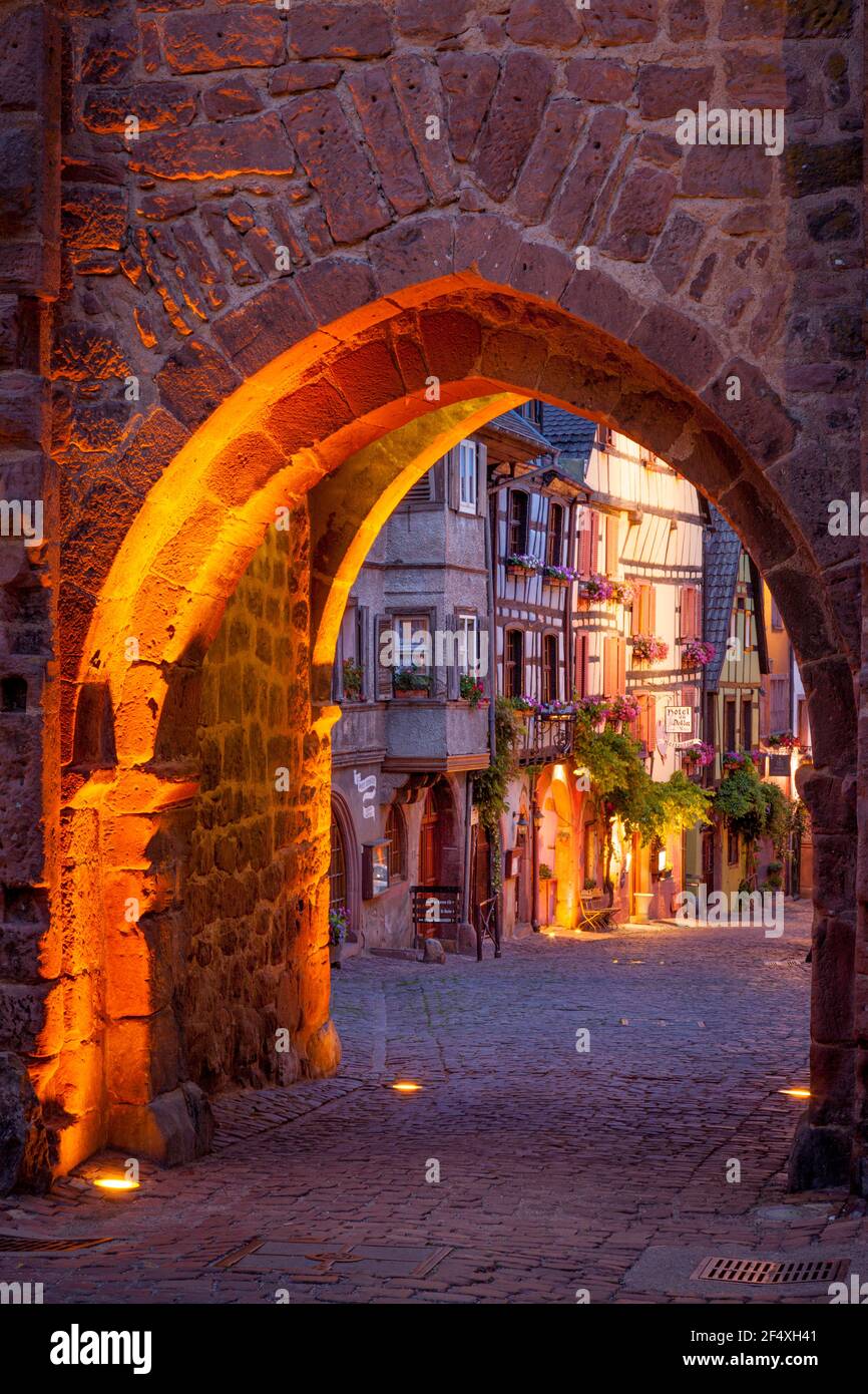 Entrata di pietra porta al borgo medievale di Riquewihr, lungo la strada del vino Alsaziano Haut-Rhin Francia Foto Stock