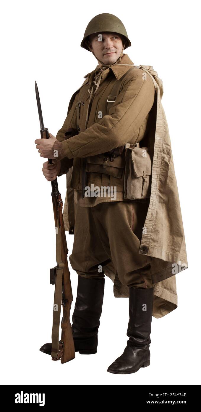 Attore maschile nella divisa invernale di un ufficiale del periodo dell'Armata Rossa seconda guerra mondiale posando su uno sfondo grigio Foto Stock