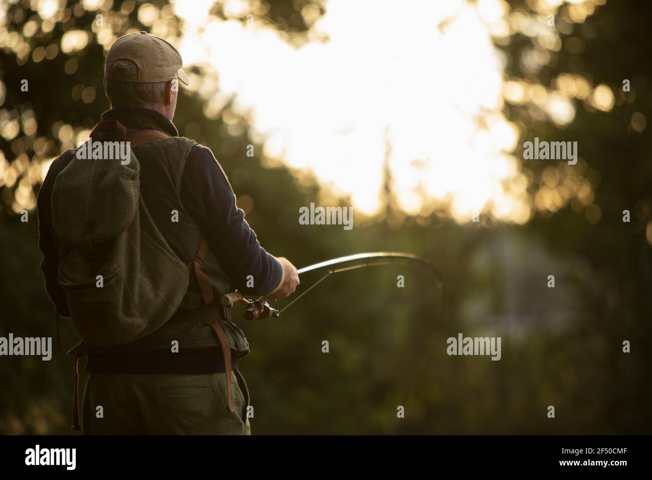 Uomo con zaino pesca a mosca Foto Stock