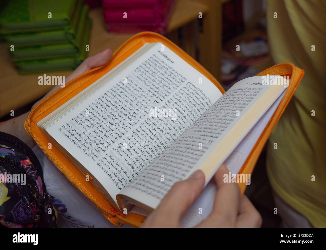 La donna sta tenendo una Bibbia aperta. Testi biblici in ebraico. La Parola di Dio. Bibbia gialla. Primo piano. Foto di alta qualità Foto Stock